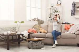 Woman staring at messy house